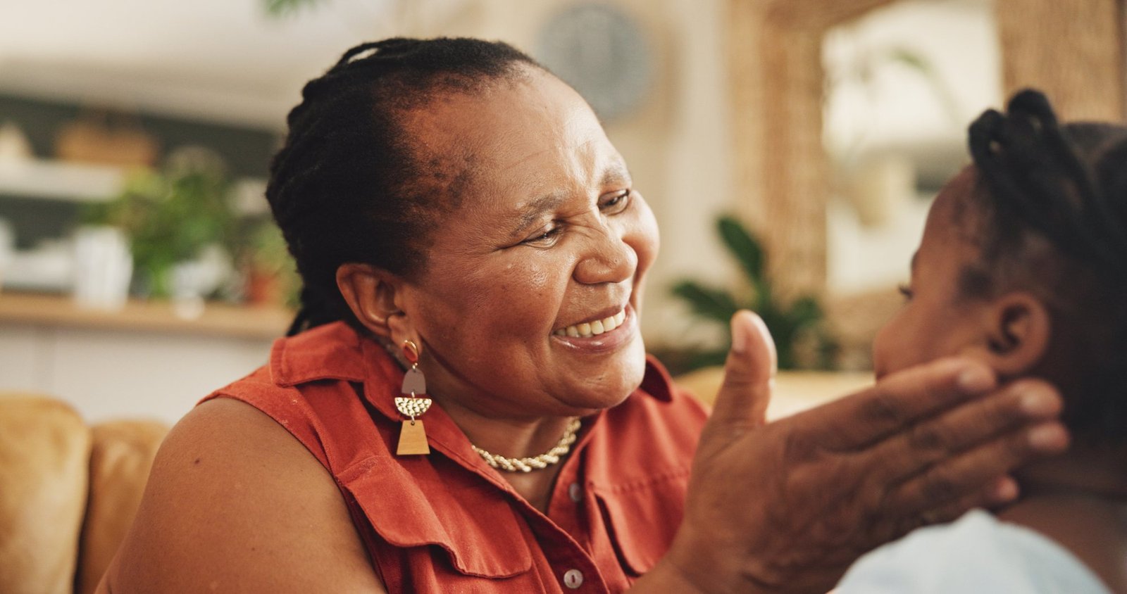 A caregiver sharing a warm laugh with a rider